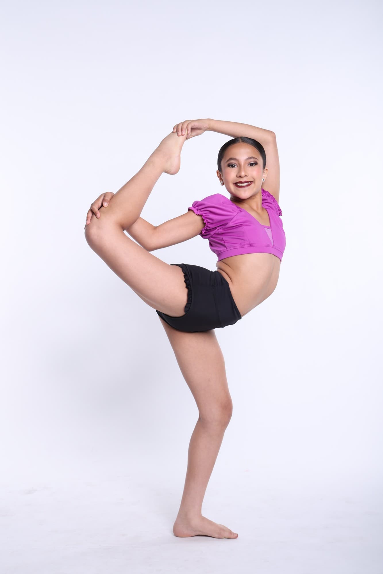 DIDC dancer in a magenta top holding a standing tilt