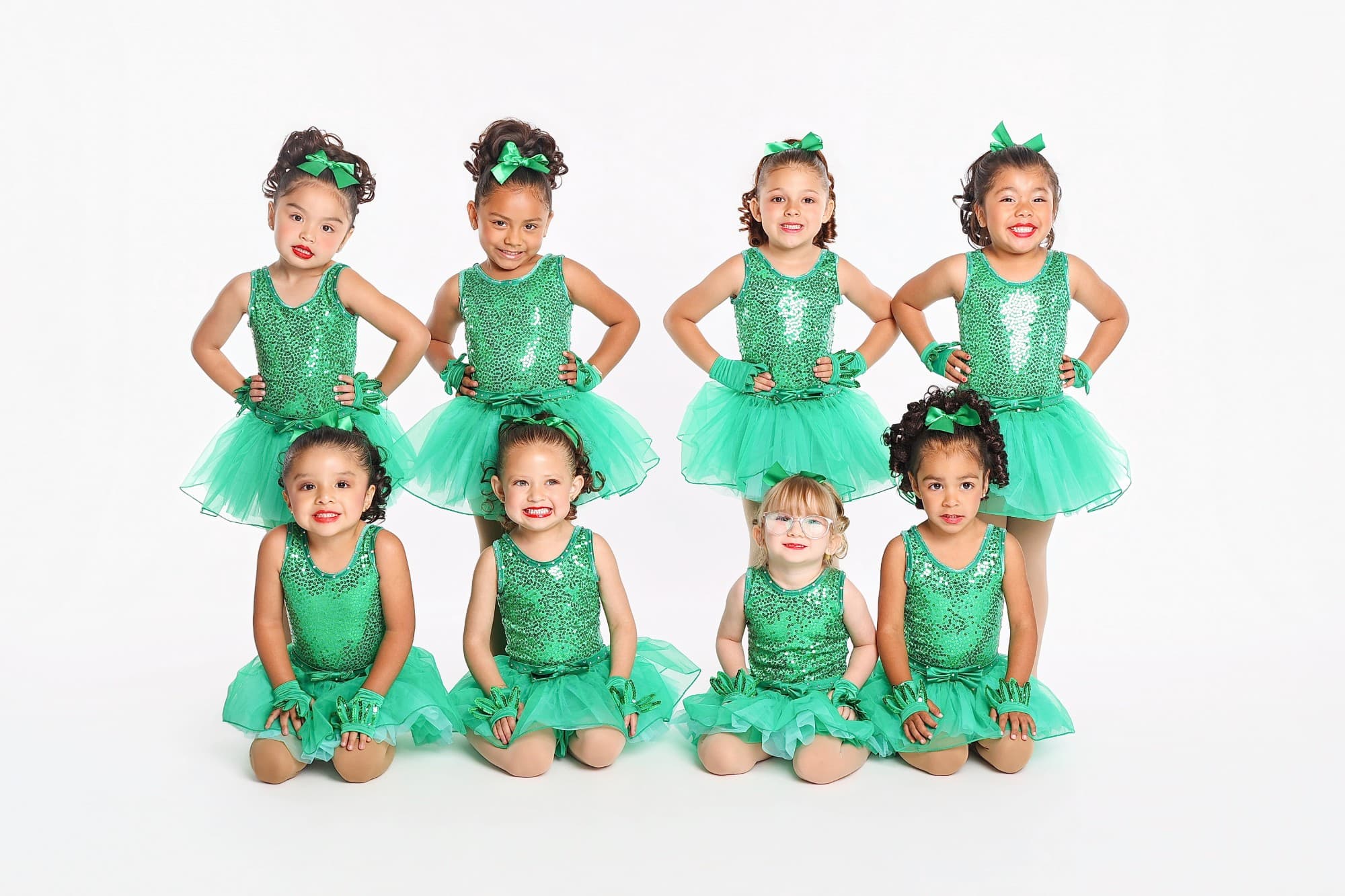 Eight of DIDC's youngest dancers in matching green sequin costumes